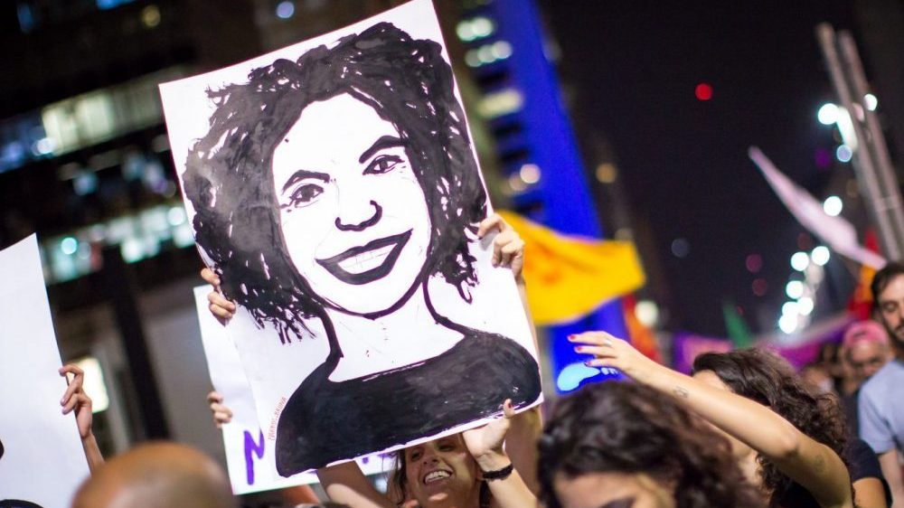 Demonstrator hold drawing of Marielle Franco Face