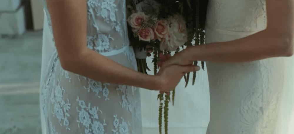 2 brides holding hands
