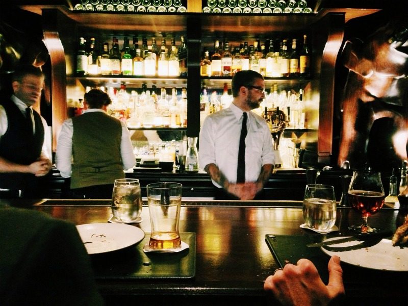 Male bartender behind a bar 