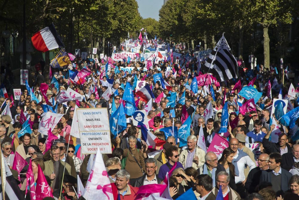 Demonstrators march with flags and placards during a rally to protest gay marriage in Paris, Sunday, Oct. 16, 2016. Thousands of people have marched in Paris to call for the repeal of a law allowing gay marriage, six months before France's next presidential election. Demonstrators march with flags and placards during a rally to protest gay marriage in Paris, Sunday, Oct. 16, 2016. Thousands of people have marched in Paris to call for the repeal of a law allowing gay marriage, six months before France's next presidential election.