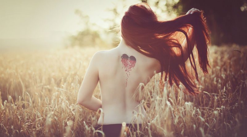 women in corn field from behind