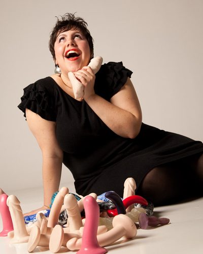 Queerie Bradshaw with selection of dildos