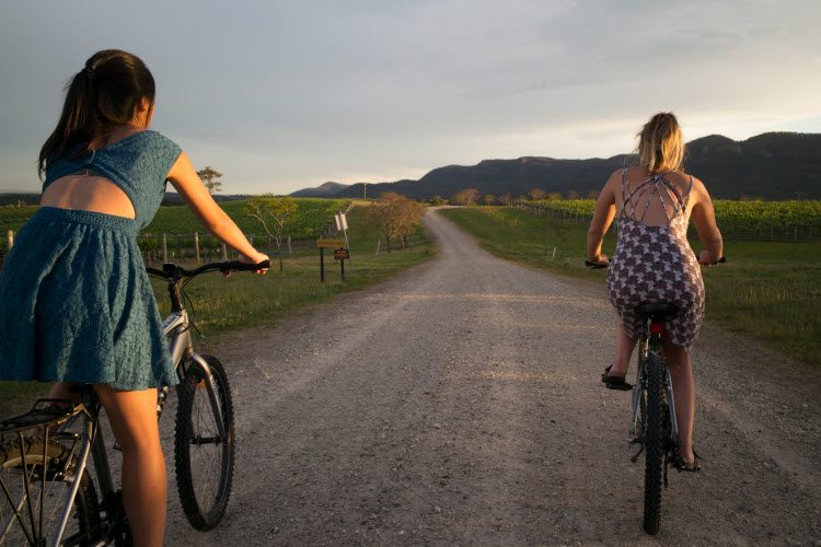 2 women riding a pushbike in the hunter valley 2 women riding a pushbike in the hunter valley