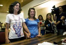 Helena Paixao, right, and Teresa Pires, left, hold hands while getting married at a civil registry office on Monday, June 7, 2010 in Lisbon. Helena Paixao, right, and Teresa Pires, left, hold hands while getting married at a civil registry office on Monday, June 7, 2010 in Lisbon.